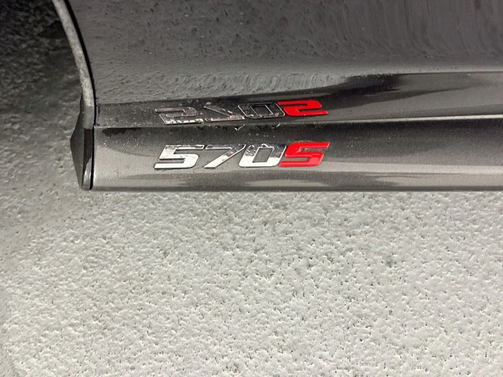 2019 McLaren 570S interior, door sill, Carbon Black, with orange accents