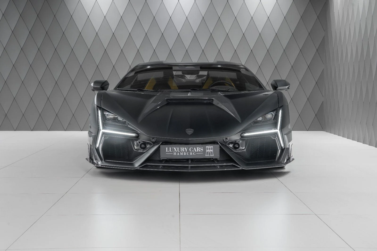 Black and carbon Lamborghini Revuelto MANSORY, full front view