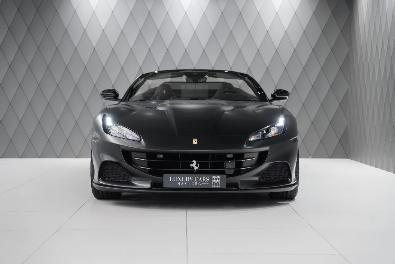 Matte dark gray Ferrari Portofino M, full front view
