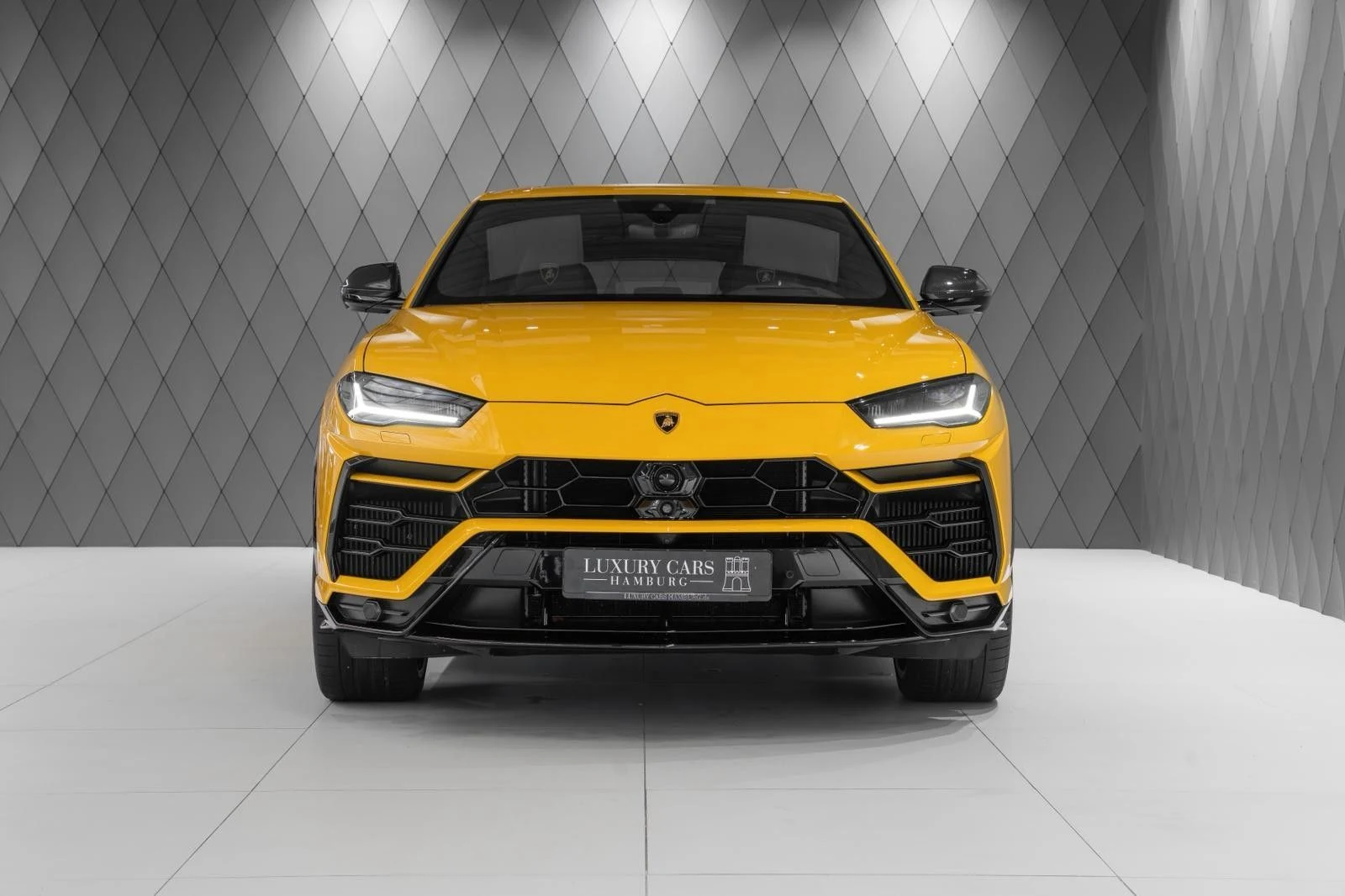 Yellow Lamborghini Urus, full front view
