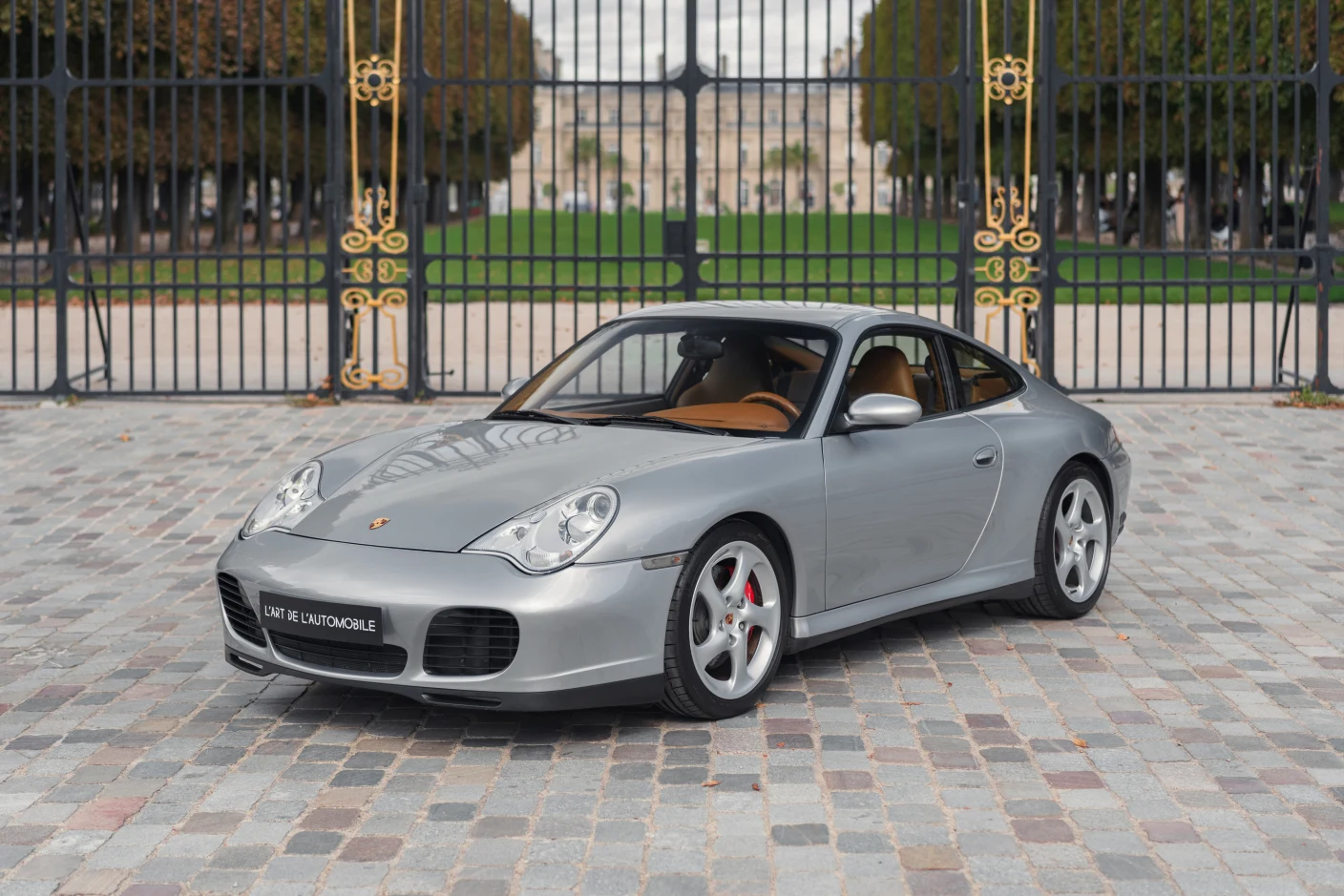 Silver Porsche 911 Carrera 4S (996), full front three-quarter view