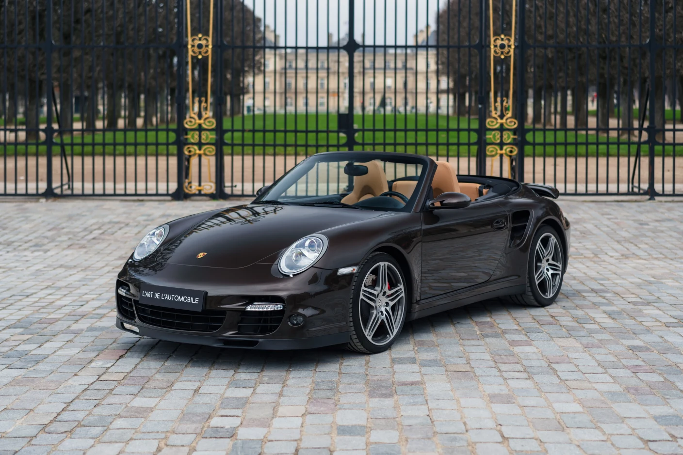 Brown Porsche 911 Turbo Cabriolet (997), full front three-quarter view