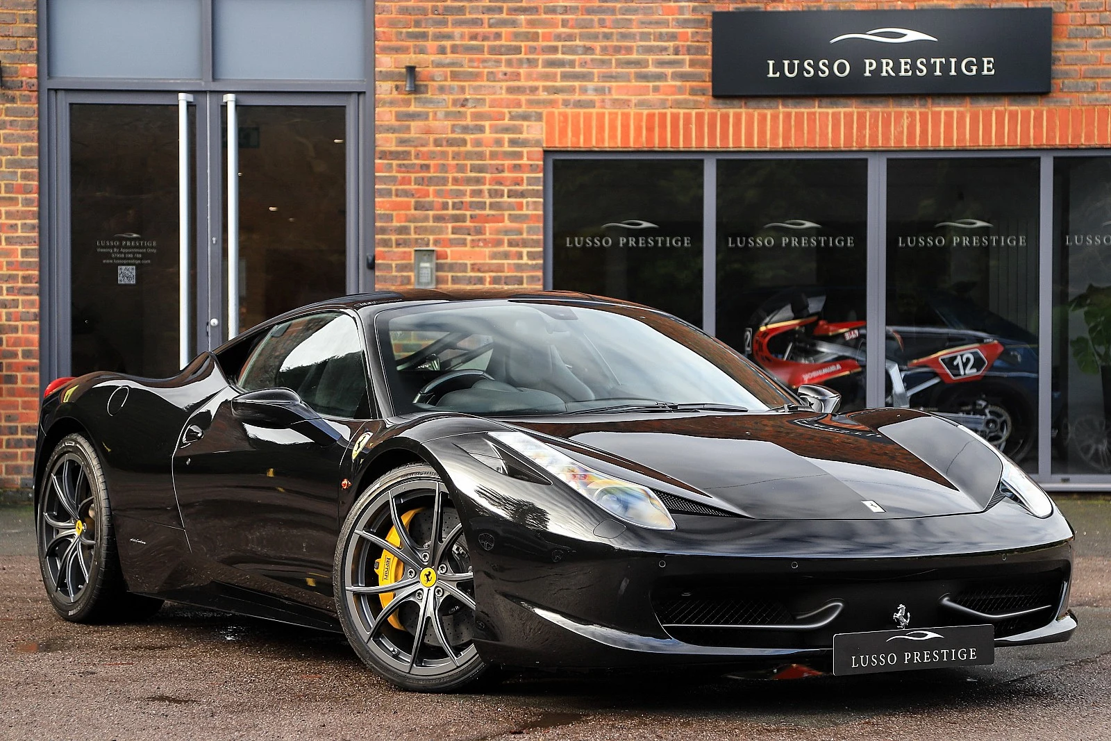 Black Ferrari 458 Italia, full front three-quarter view
