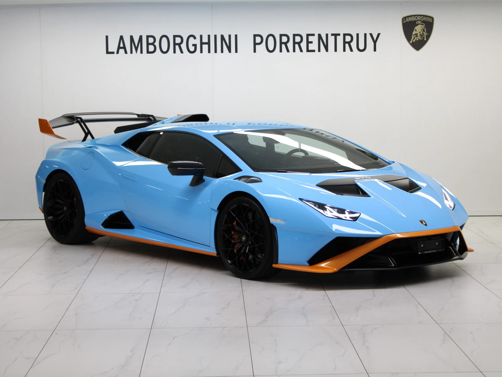 Blue Lamborghini Huracán STO, full front three-quarter view