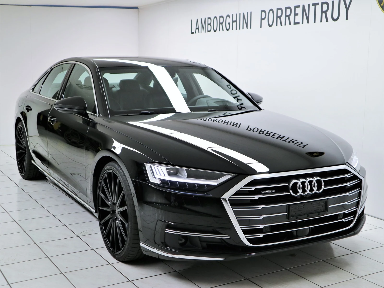 Black Audi A8 55 TFSI quattro, full front three-quarter view