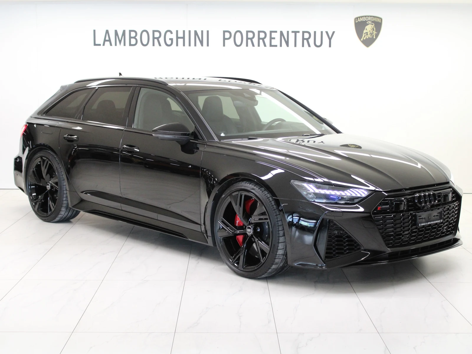 Black Audi RS 6 Avant, full front three-quarter view