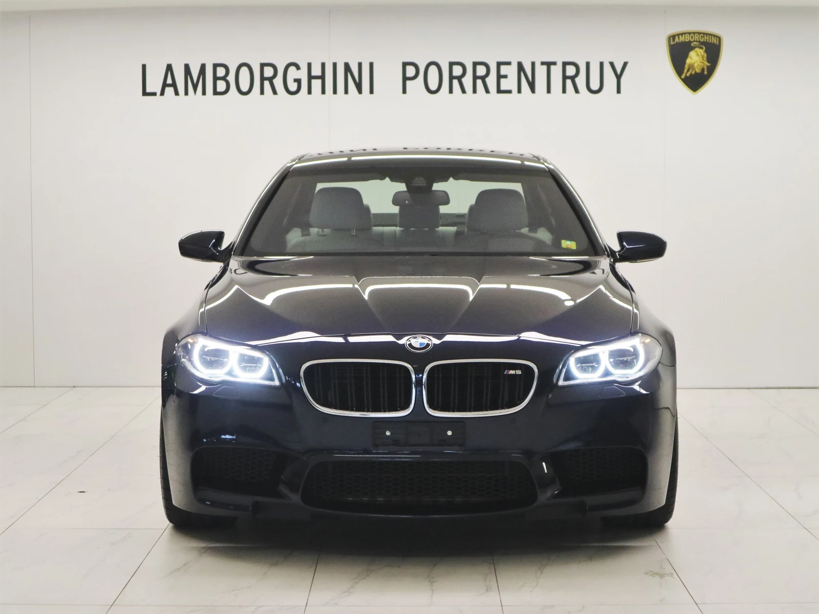Blue BMW M5 (F10), full front view