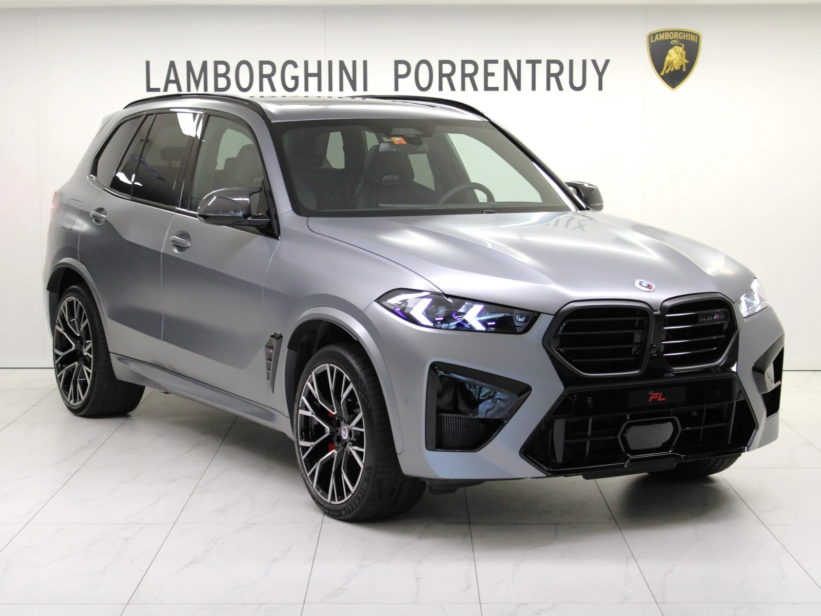 Gray BMW X5 M Competition, full front three-quarter view