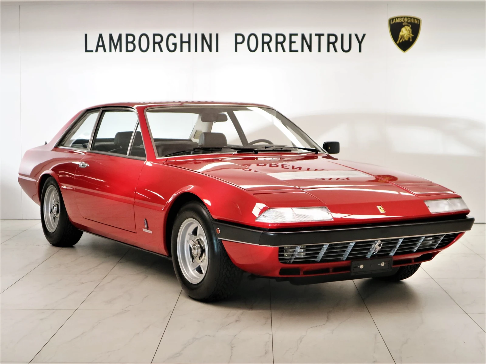 Red Ferrari 365 GT4 2+2, full front three-quarter view