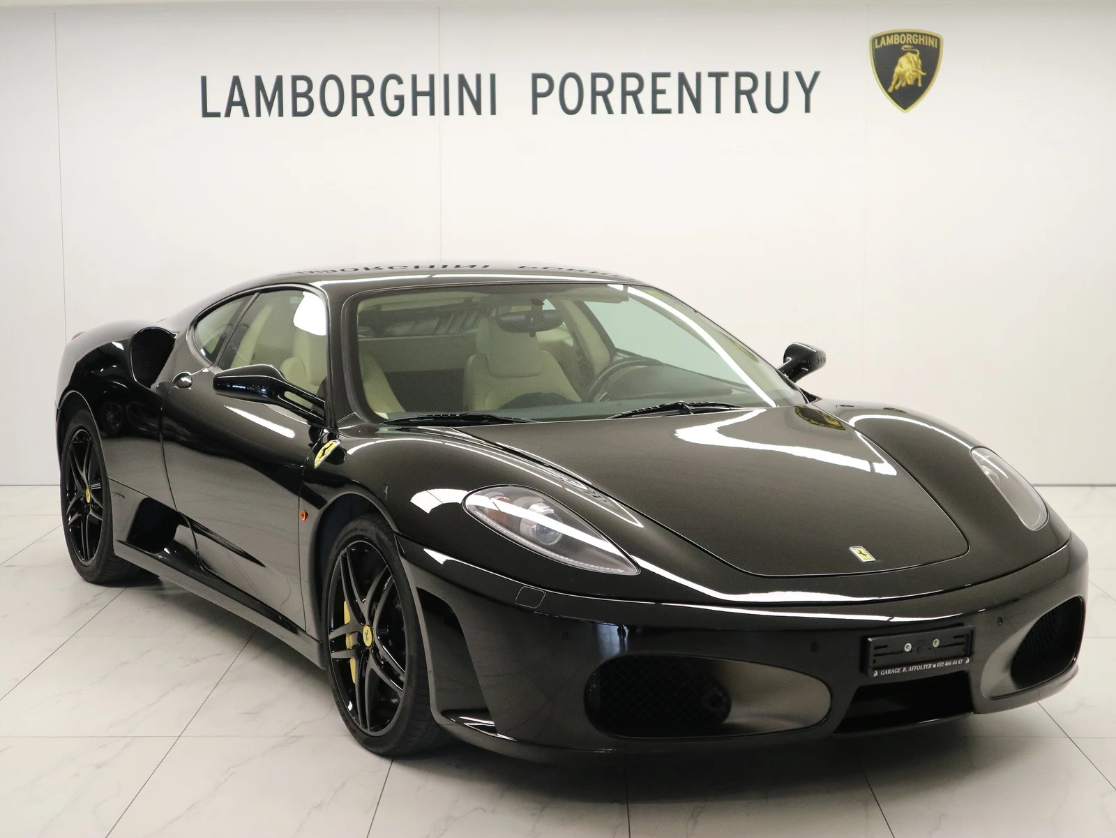 Black Ferrari F430, full front three-quarter view