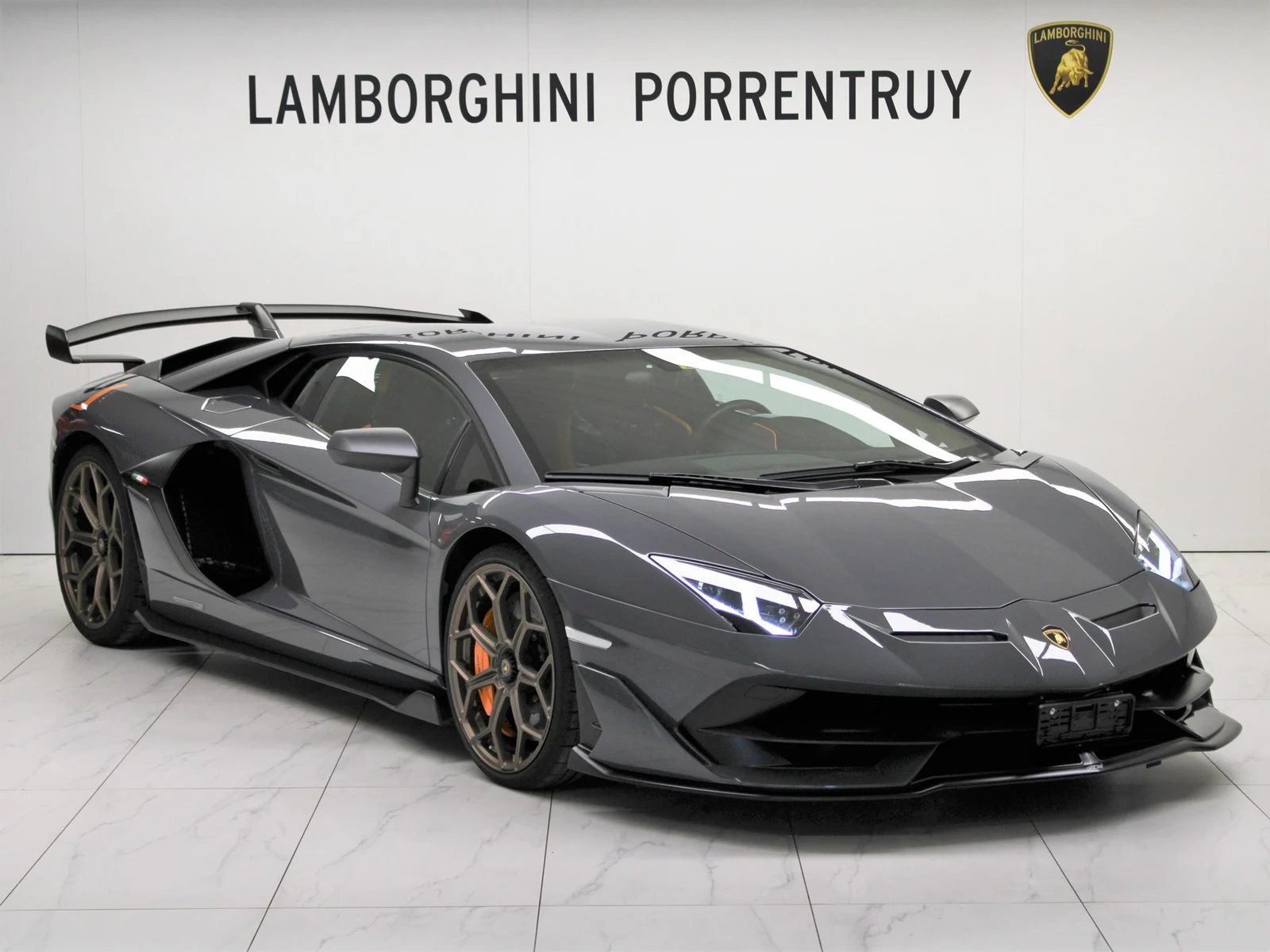 Gray Lamborghini Aventador SVJ, full front three-quarter view