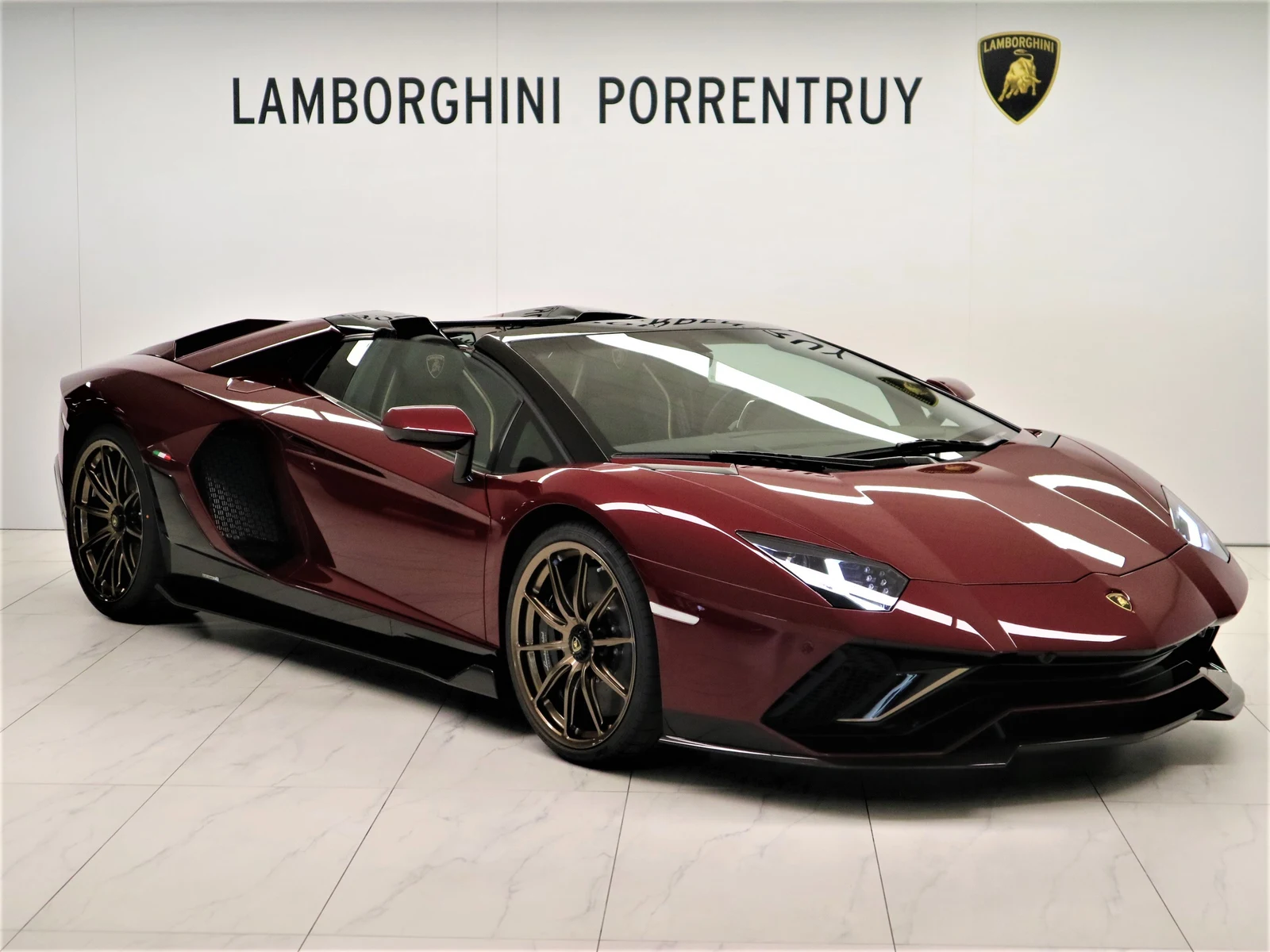 Burgundy Lamborghini Aventador LP 780-4 Ultimae Roadster, full front three-quarter view