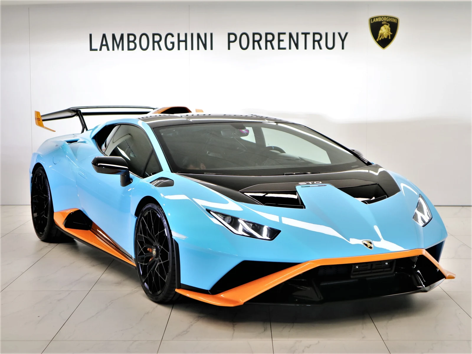 Blue Lamborghini Huracán STO, full front three-quarter view