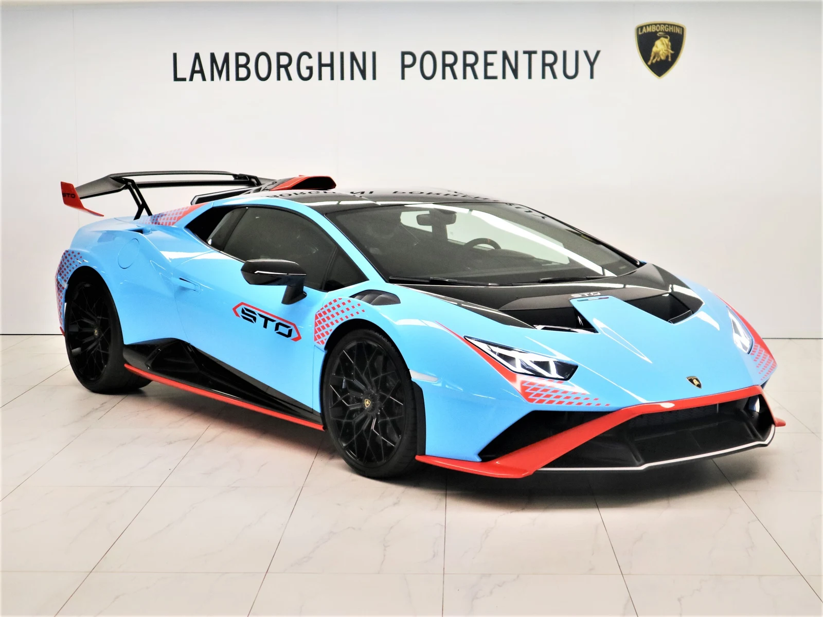 Blue Lamborghini Huracán STO, full front three-quarter view