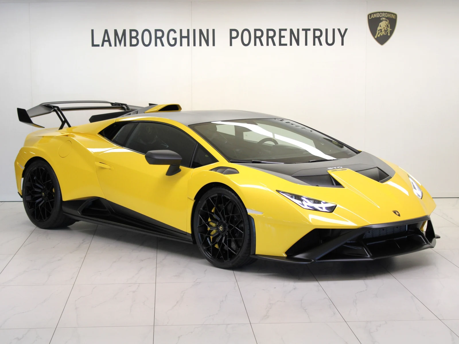 Yellow Lamborghini Huracán STO, full front three-quarter view