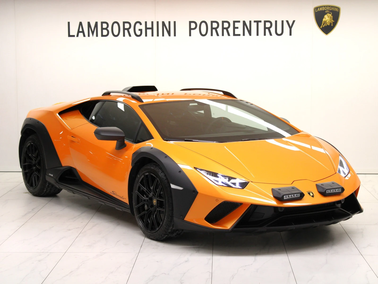 Orange Lamborghini Huracán Sterrato, full front three-quarter view