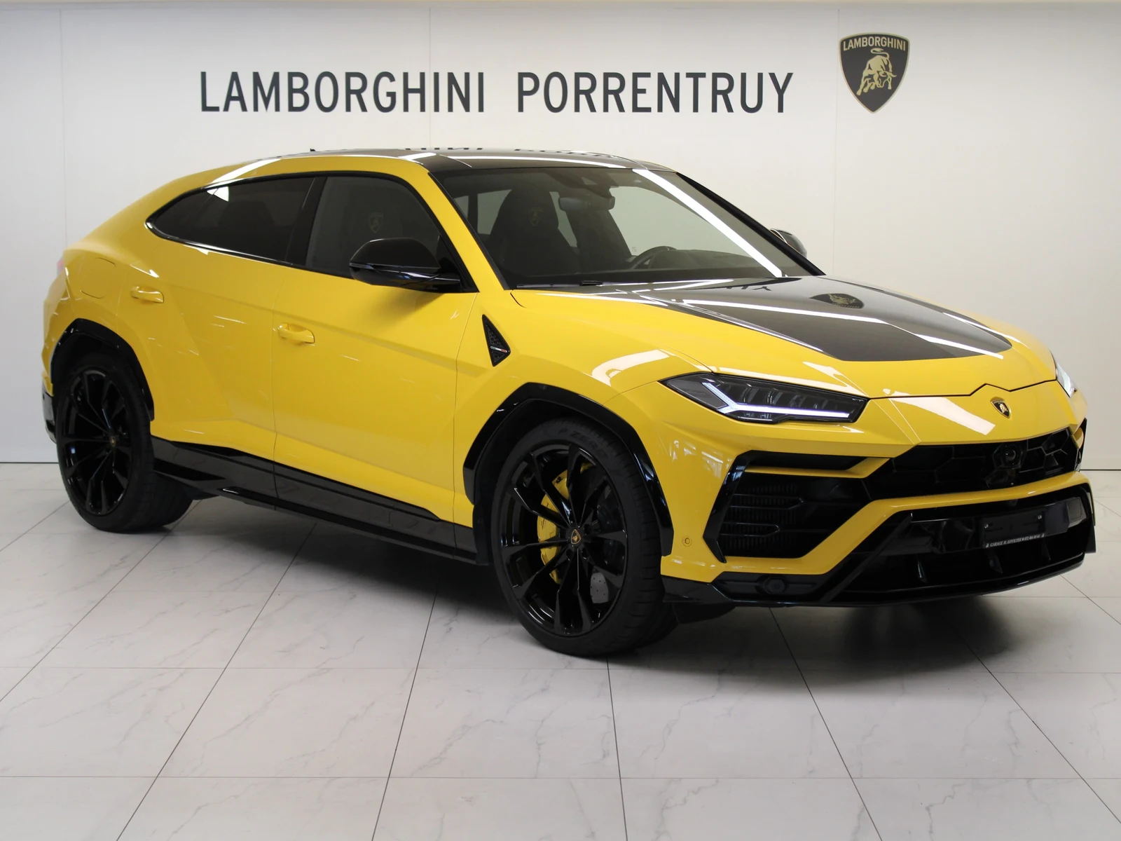 Yellow Lamborghini Urus, full front three-quarter view
