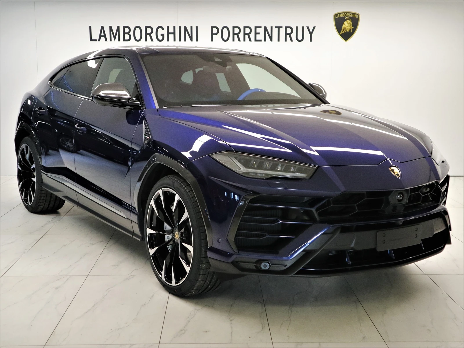 Blue Lamborghini Urus, full front three-quarter view
