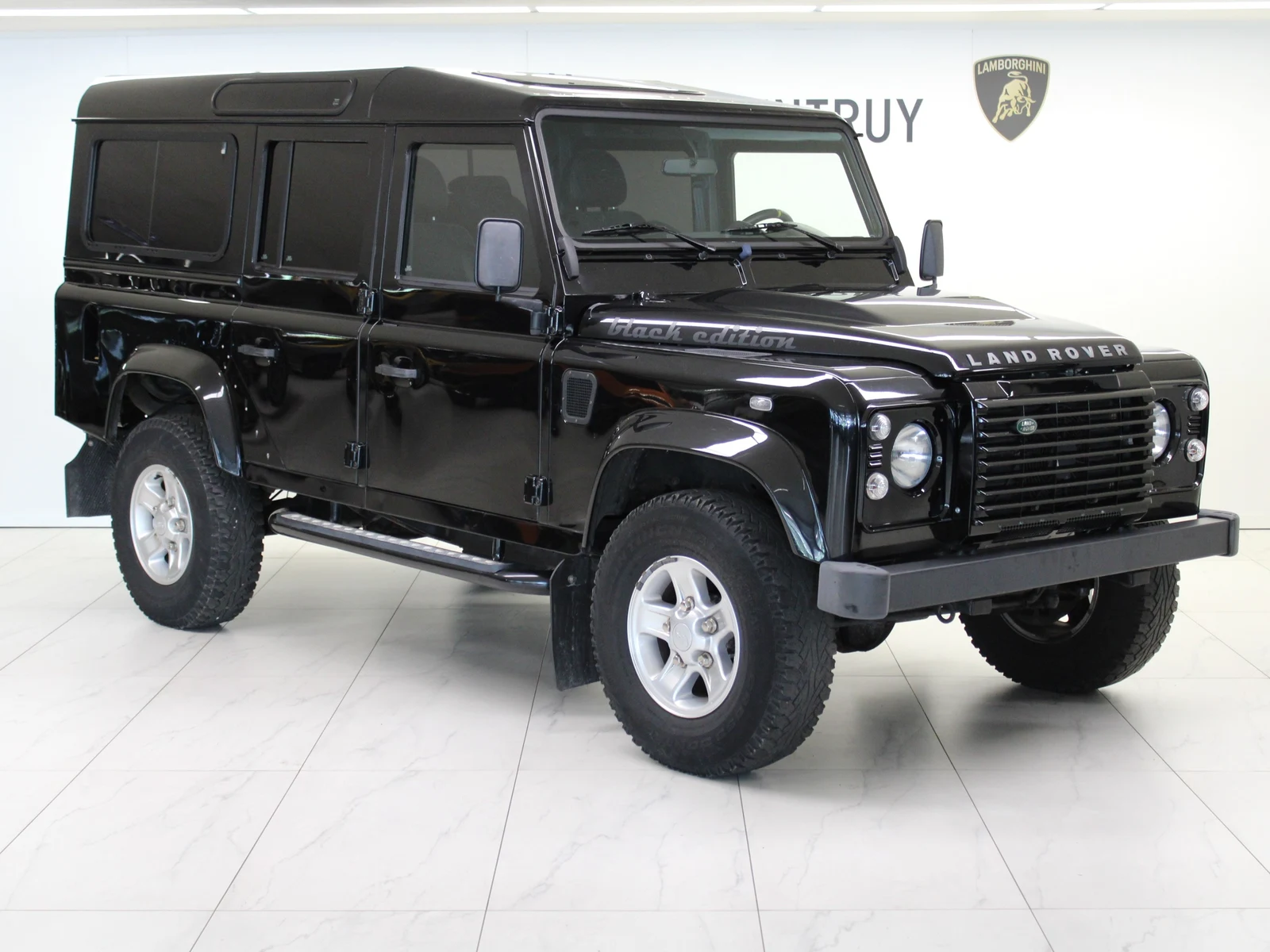 Black Land Rover Defender 110 Td4 Station Wagon, full front three-quarter view