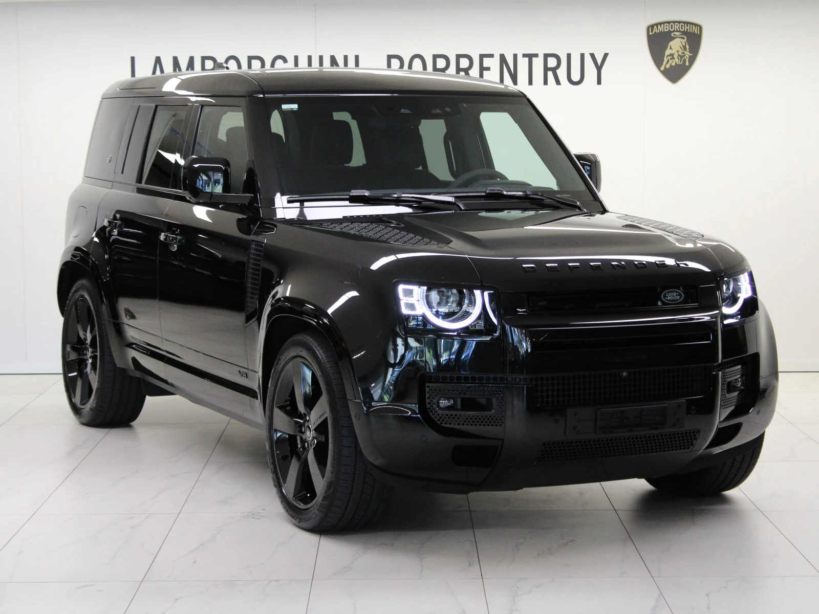 Black Land Rover Defender 110 V8, full front three-quarter view