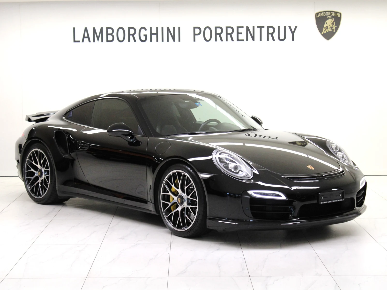 Black Porsche 911 Turbo S (991), full front three-quarter view