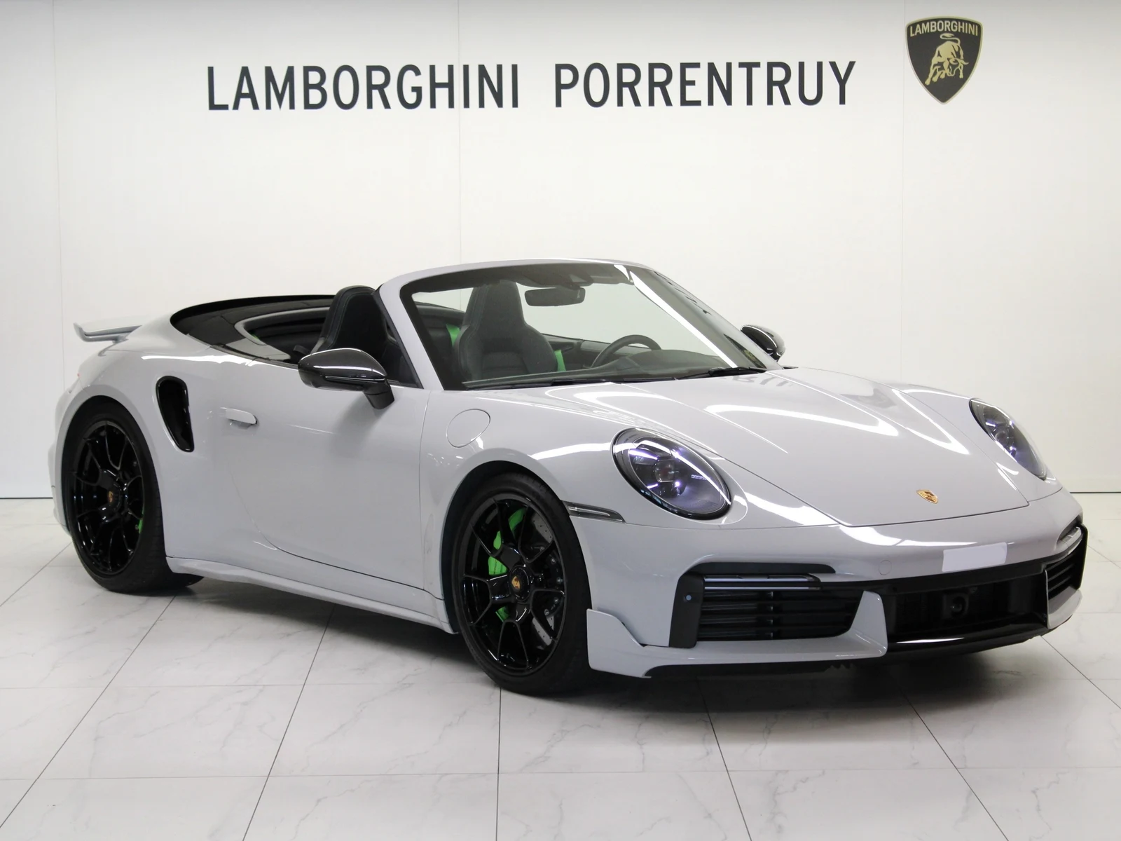 Black Porsche 911 Turbo S Cabriolet (992), full front three-quarter view