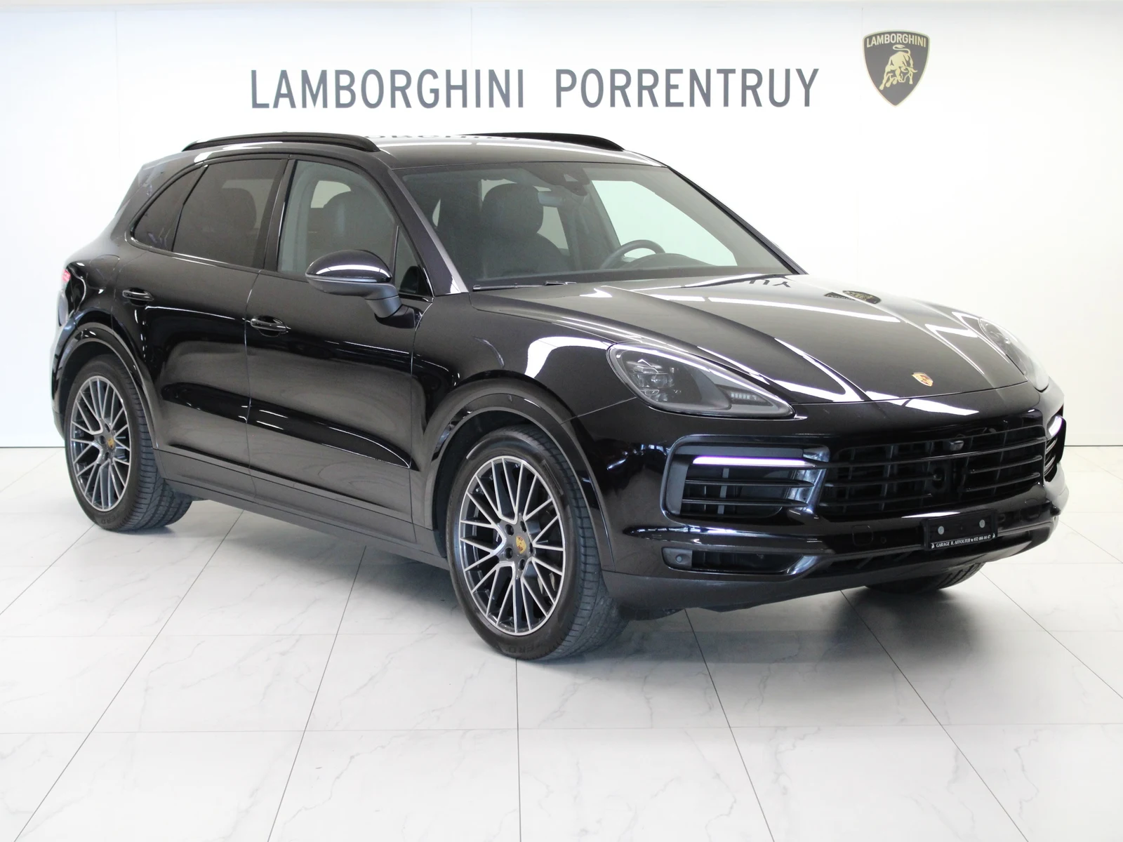 Black Porsche Cayenne (E3), full front three-quarter view