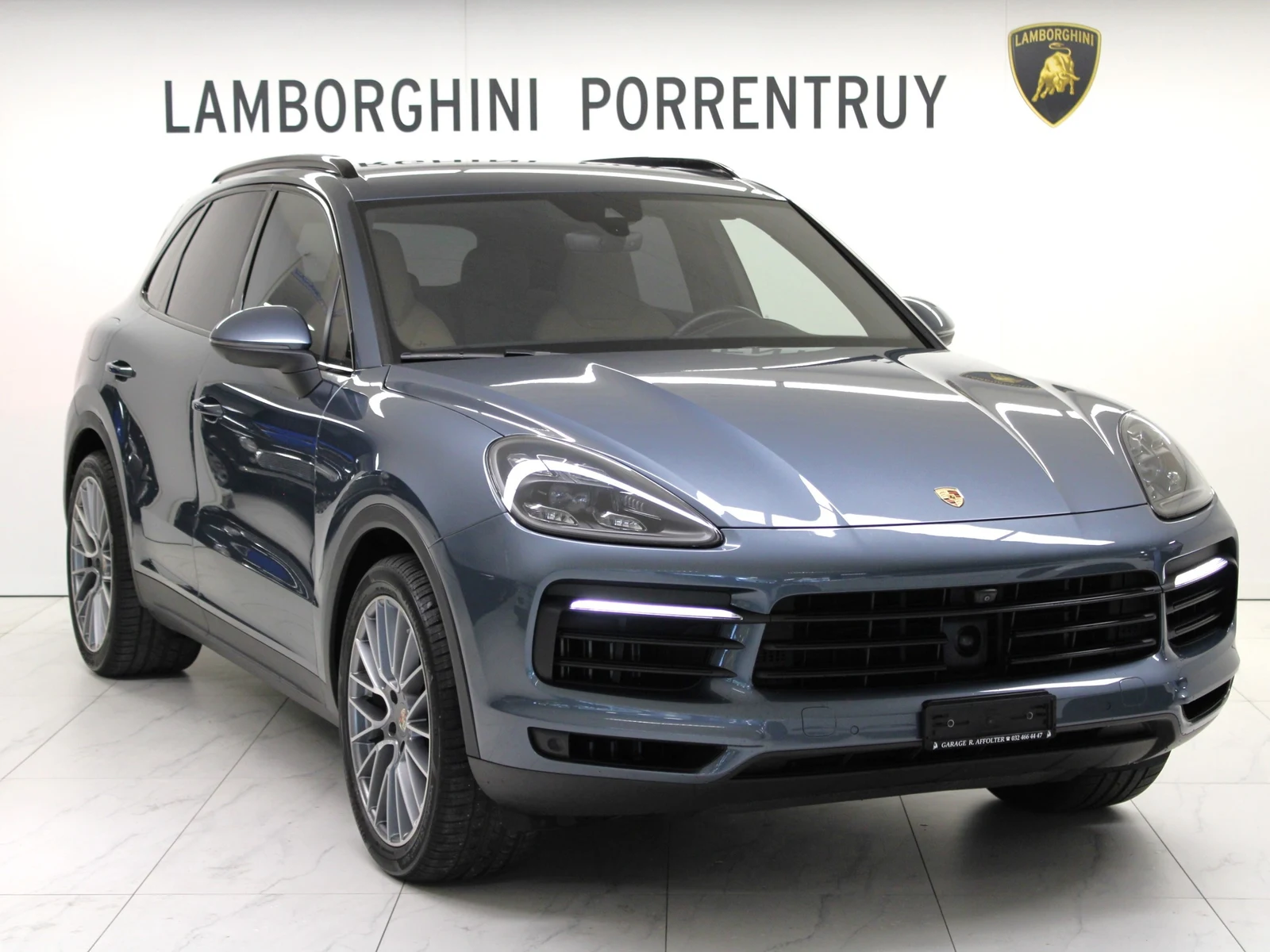 Blue Porsche Cayenne S (E3), full front three-quarter view