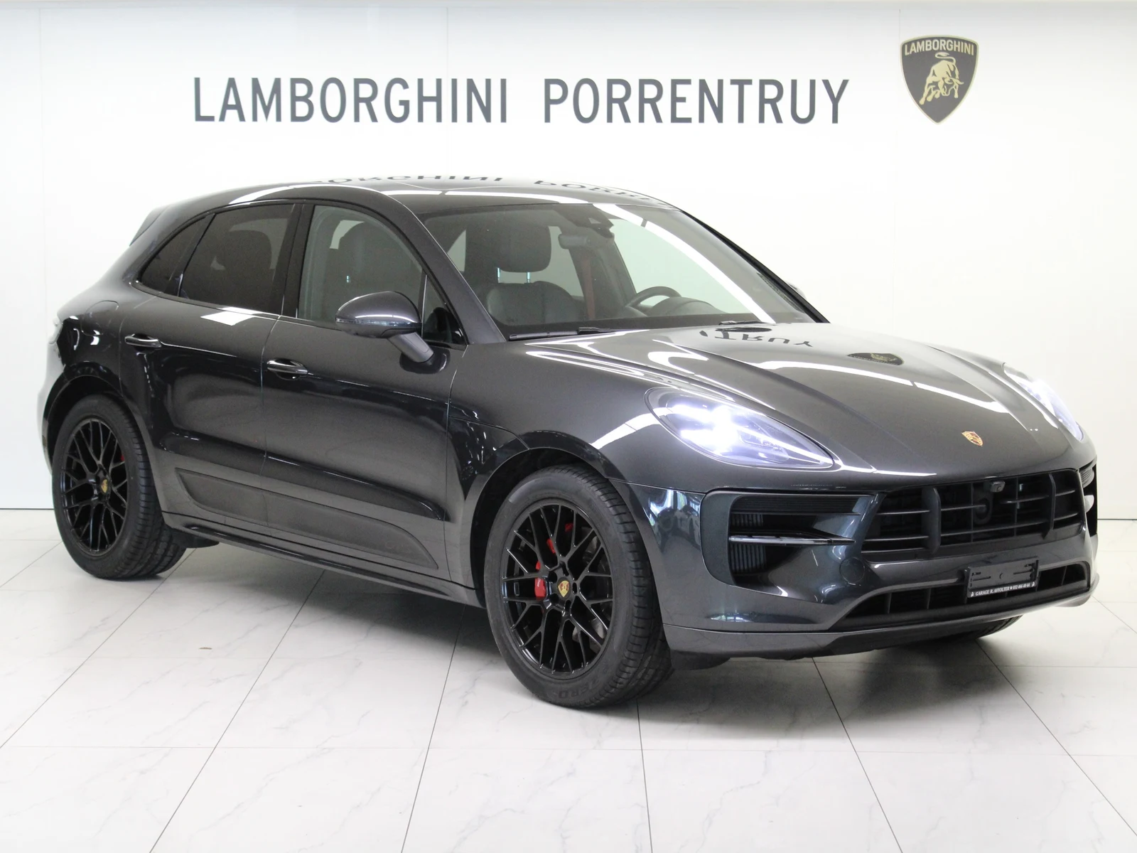 Anthracite gray Porsche Macan GTS, full front three-quarter view