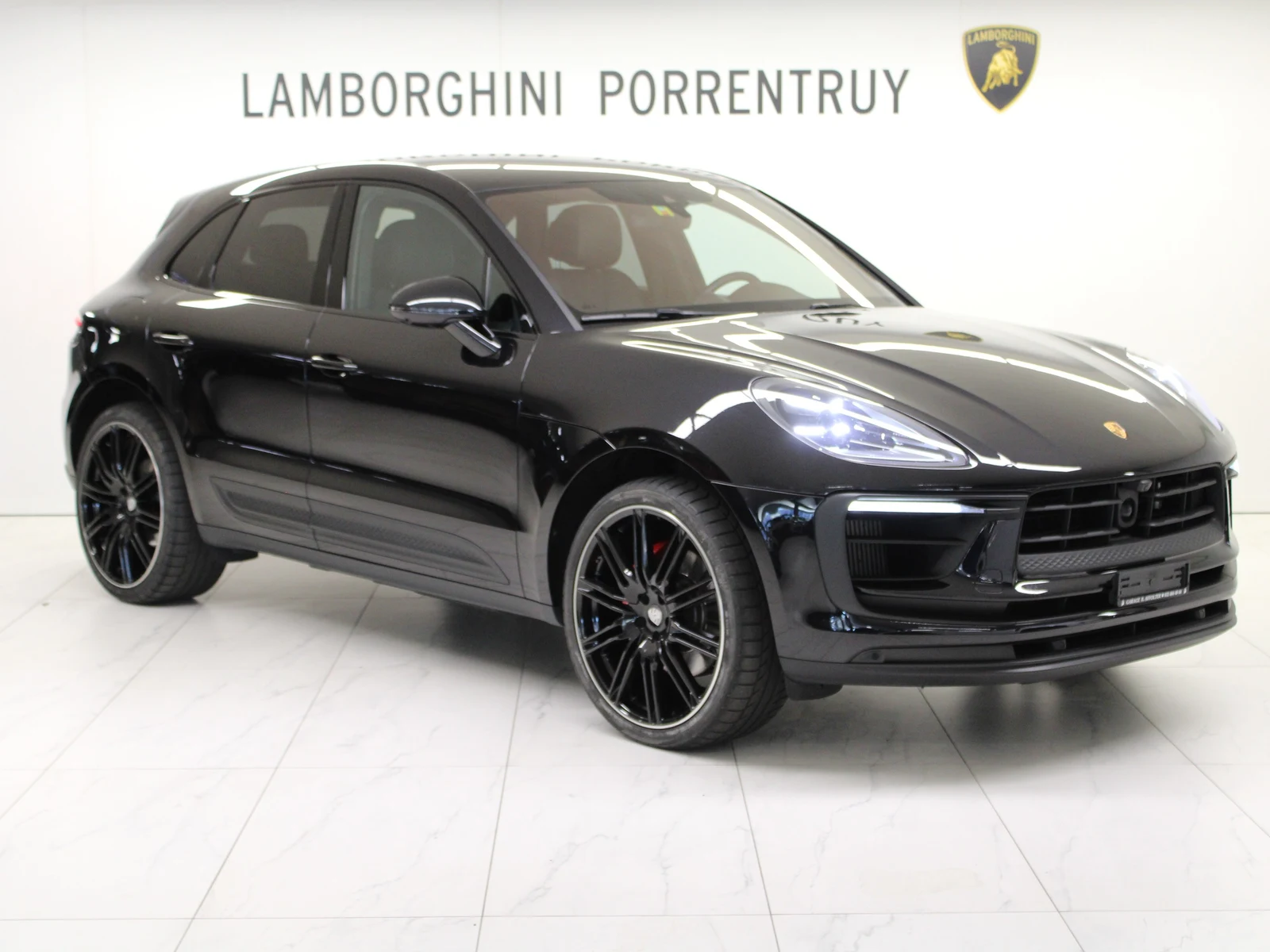 Black Porsche Macan S, full front three-quarter view