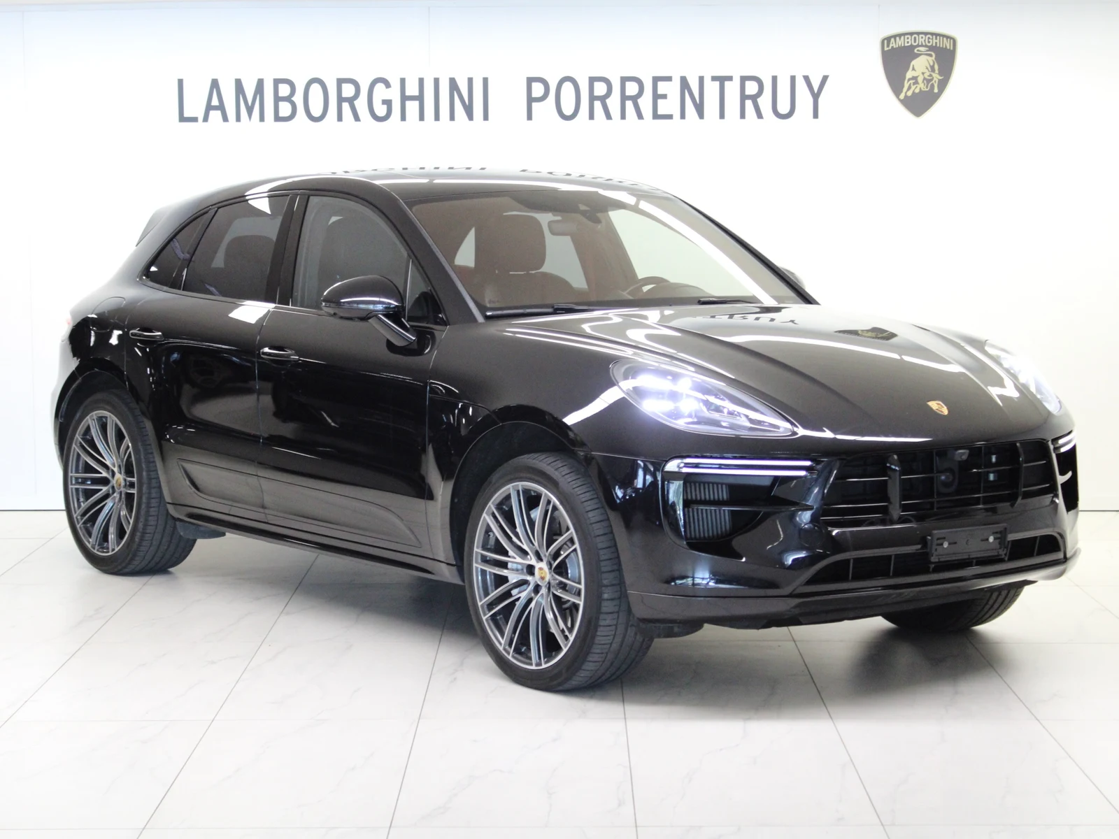 Black Porsche Macan Turbo, full front three-quarter view