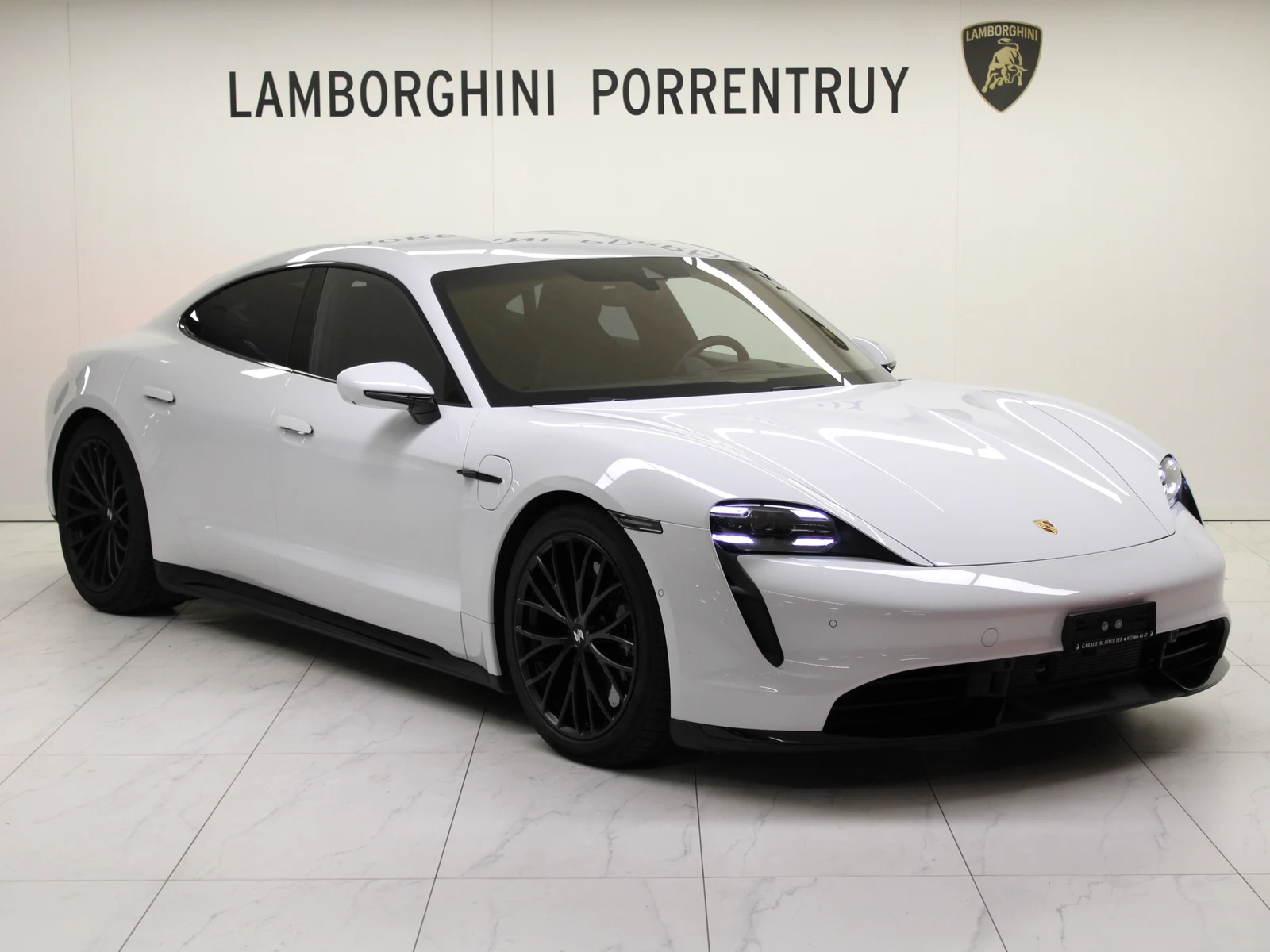 White Porsche Taycan Turbo S, full front three-quarter view