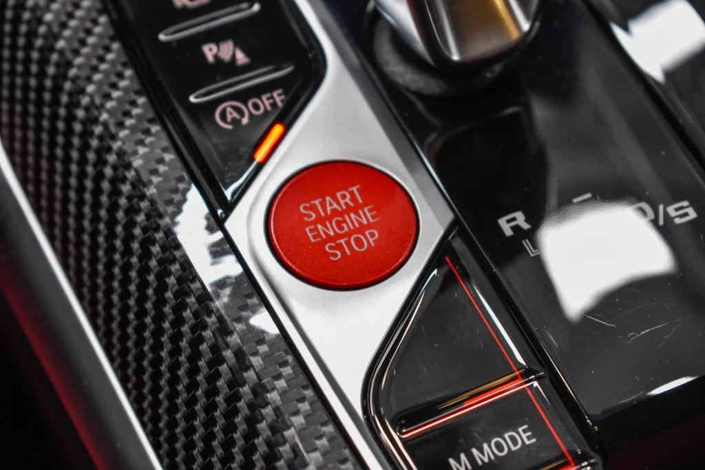 2024 BMW M4 Competition interior, center console, Fiona Red/Black