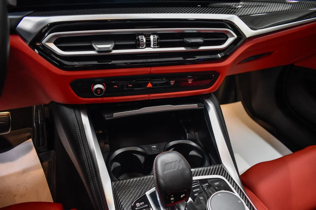 2024 BMW M4 Competition interior, center console, Fiona Red/Black