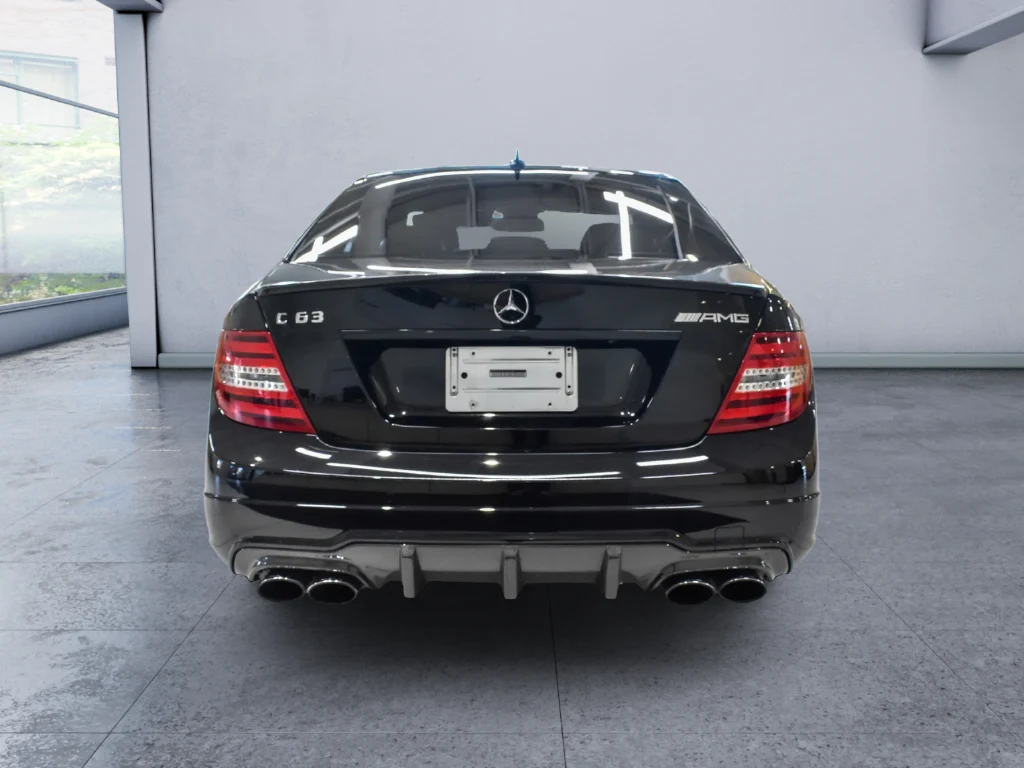2013 Mercedes-Benz C 63 AMG Sedan, rear three-quarter view, Black
