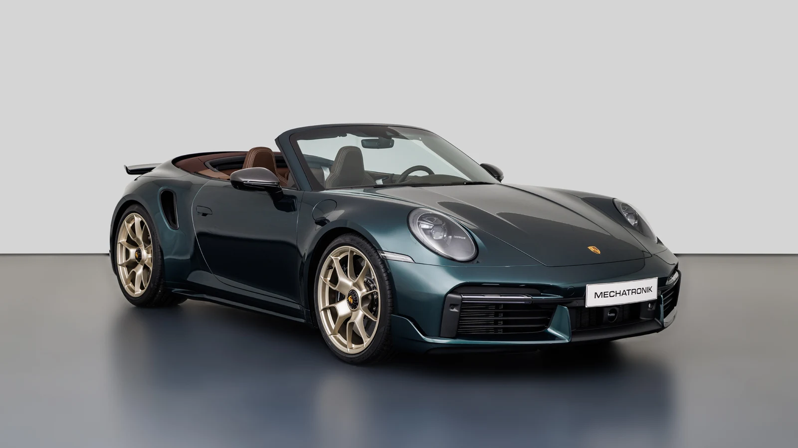 Forest Green Porsche 911 Turbo S Cabriolet (992), full front three-quarter view