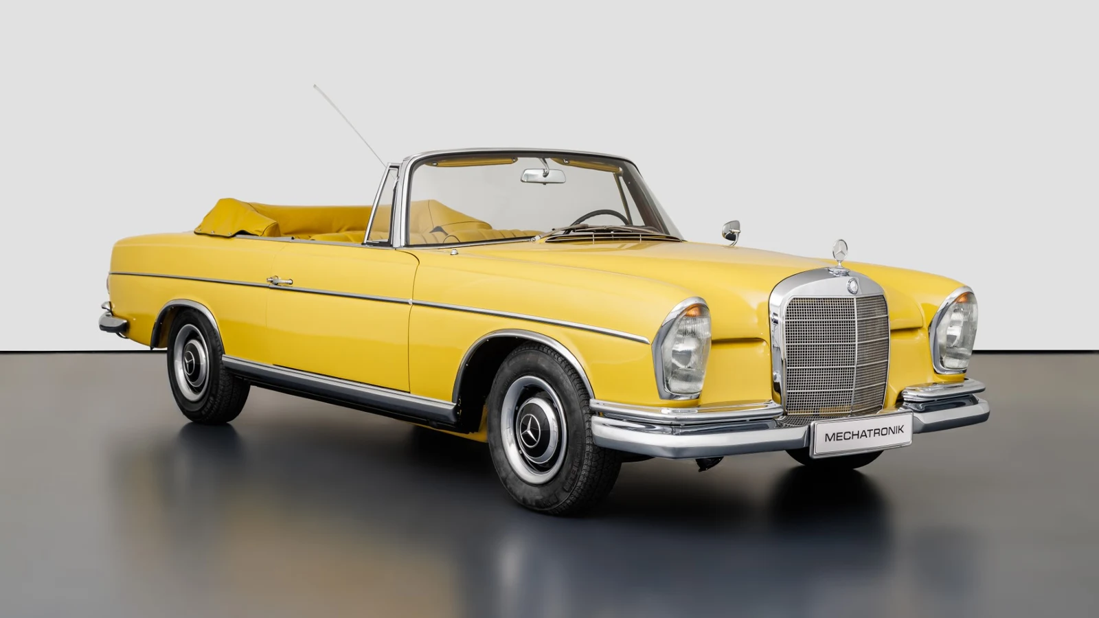 Yellow Mercedes-Benz 300 SE Convertible, full front three-quarter view