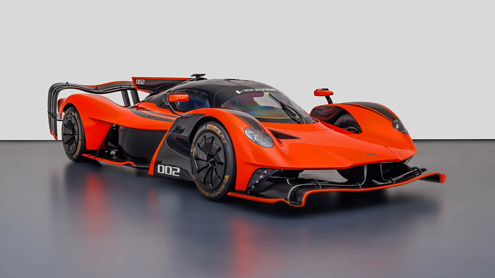 Orange Aston Martin Valkyrie AMR Pro, full front three-quarter view