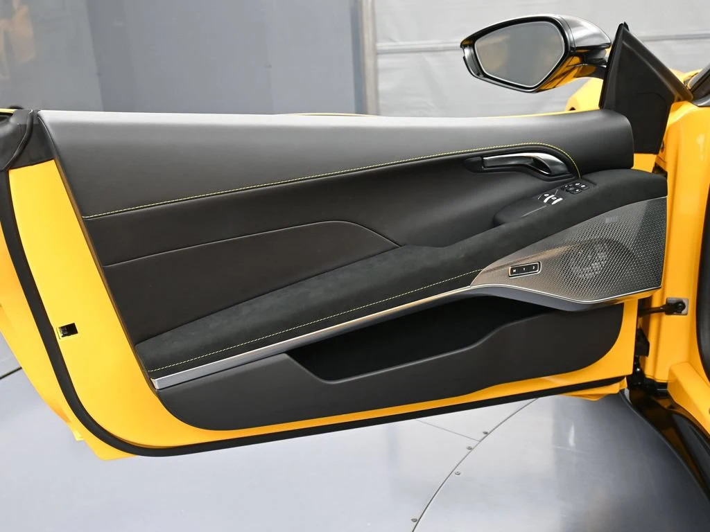 2025 Lotus Emira V6 interior, door panel, Black Alcantara with Yellow Stitch