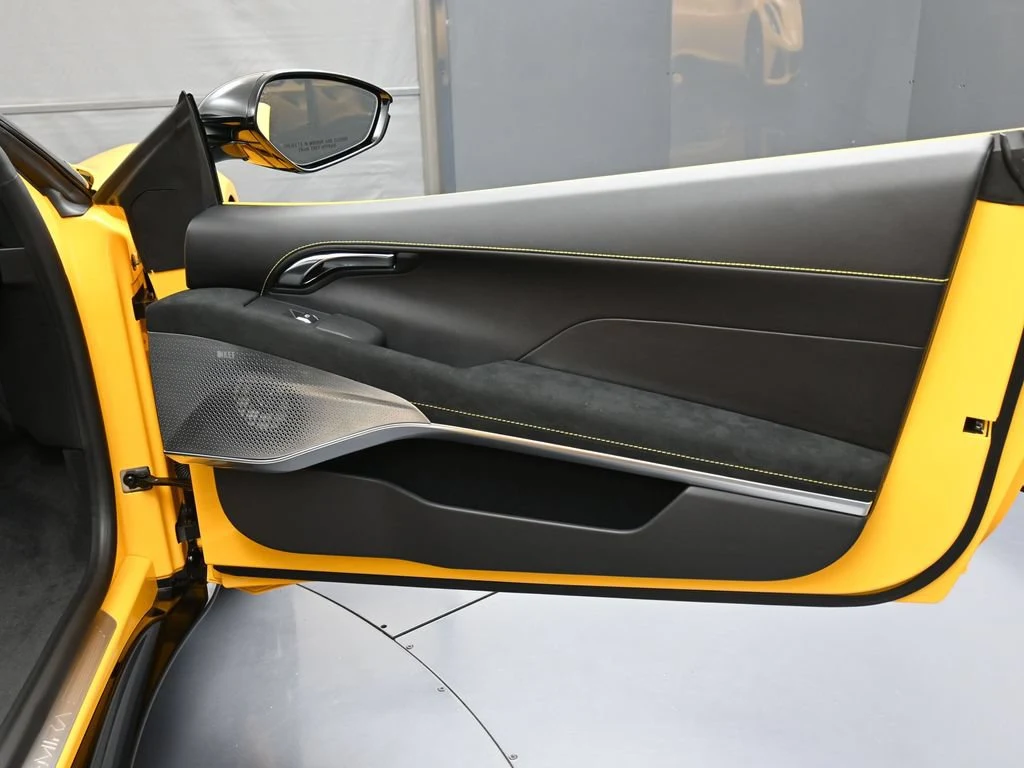 2025 Lotus Emira V6 interior, door panel, Black Alcantara with Yellow Stitch