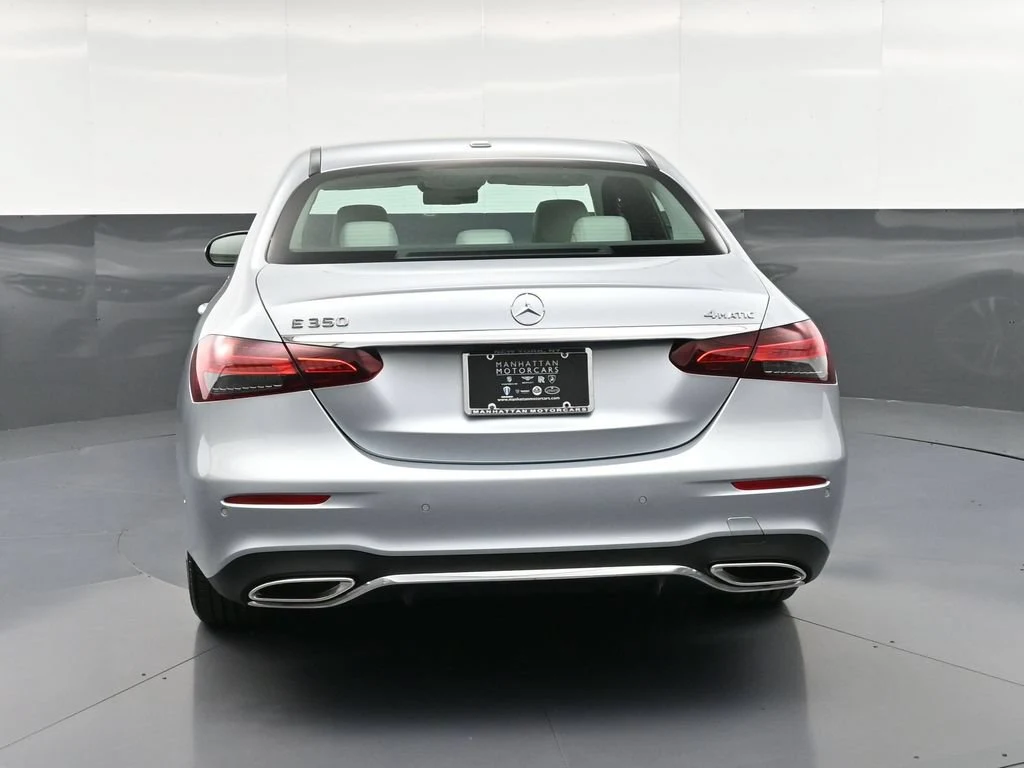 2023 Mercedes-Benz E 350 4MATIC, rear three-quarter view, Silver