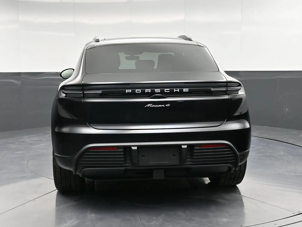 2026 Porsche Macan 4 Electric, rear three-quarter view, Black