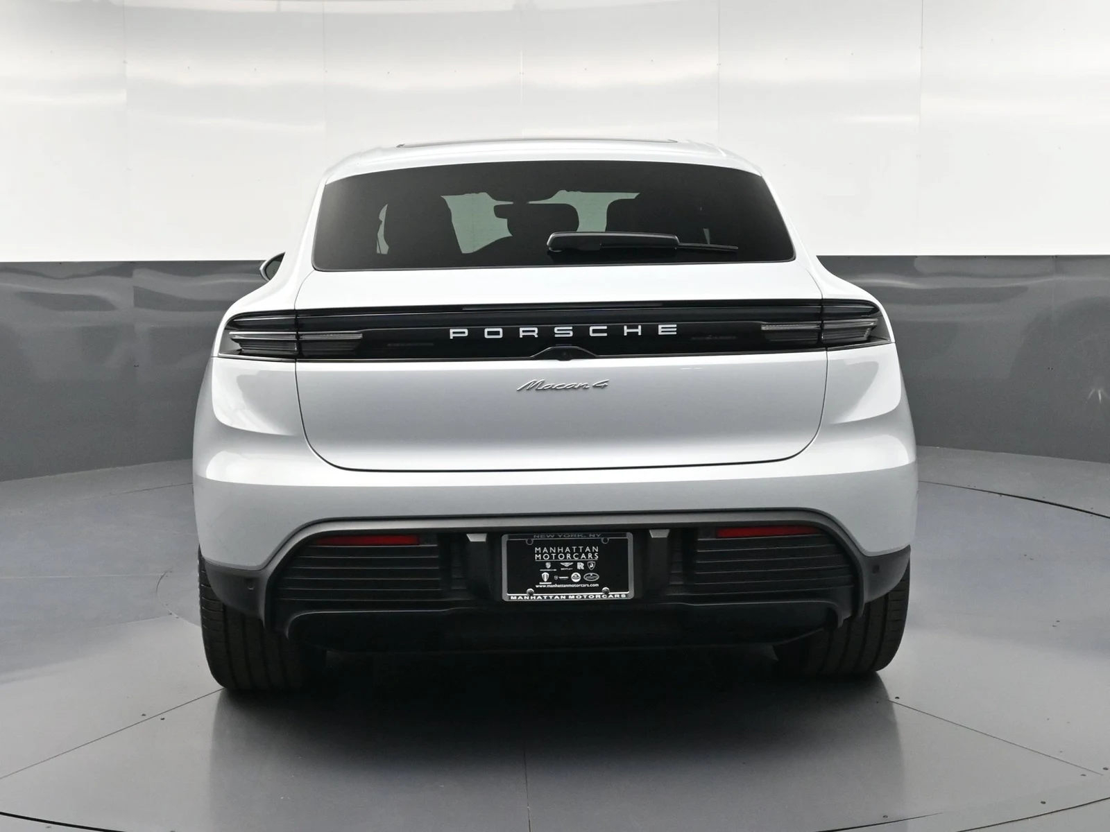 2026 Porsche Macan 4 Electric, rear three-quarter view, Silver