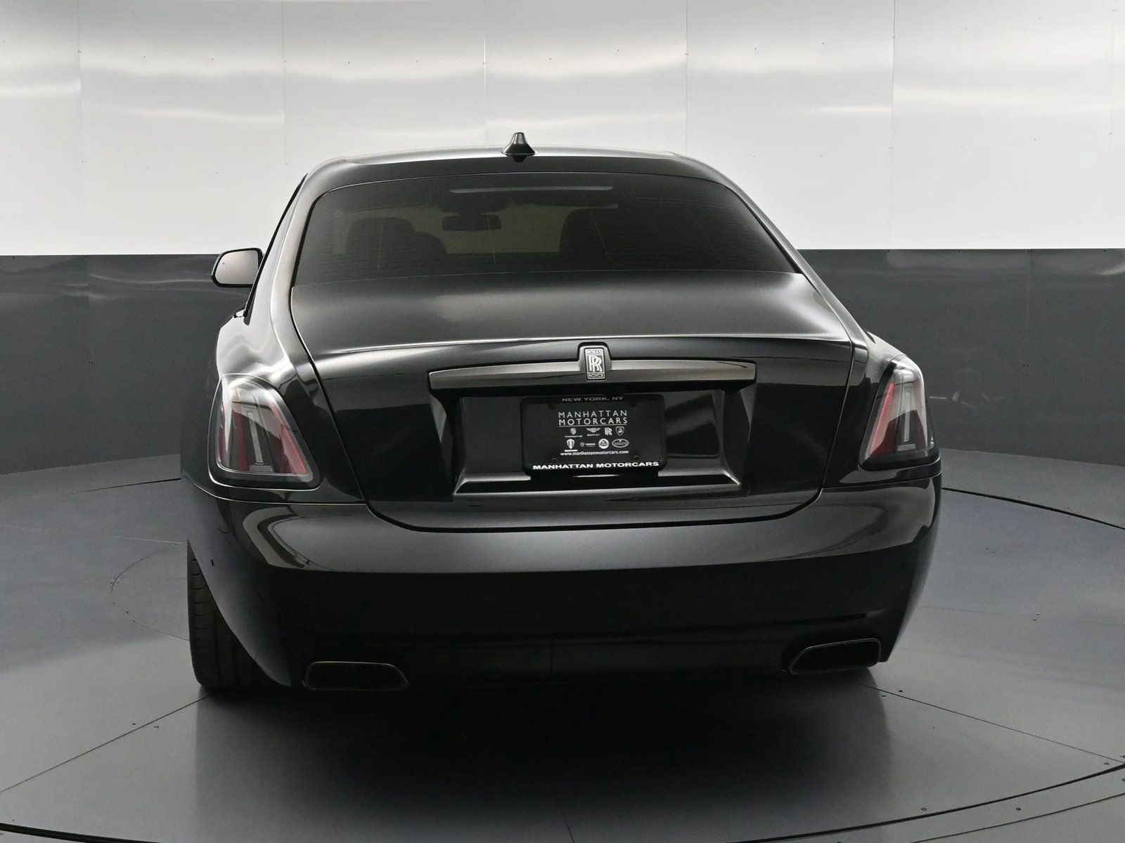 2025 Rolls-Royce Black Badge Ghost, rear three-quarter view, Black
