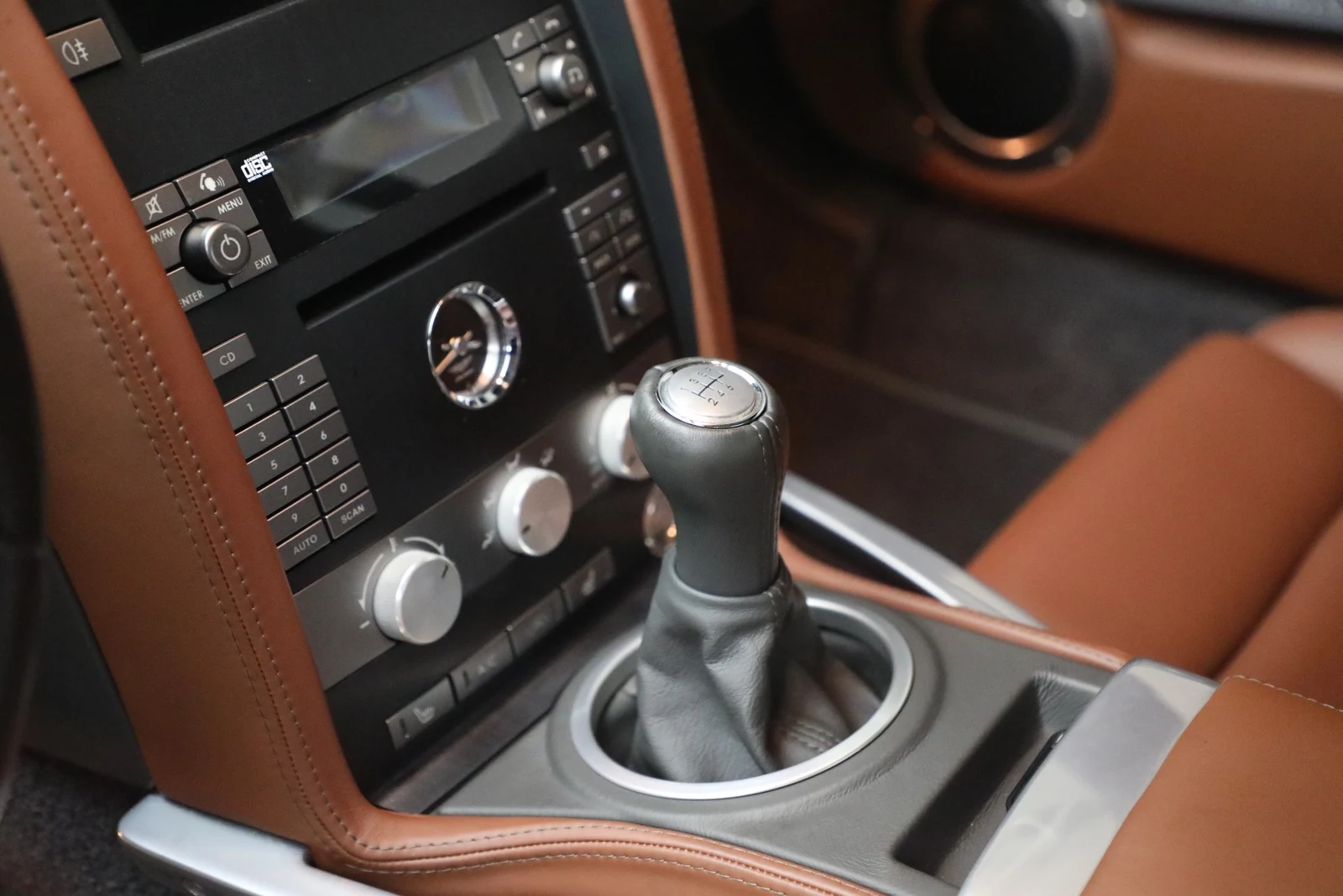 2006 Aston Martin V12 Vanquish S interior, center console, Centenary Saddle Tan