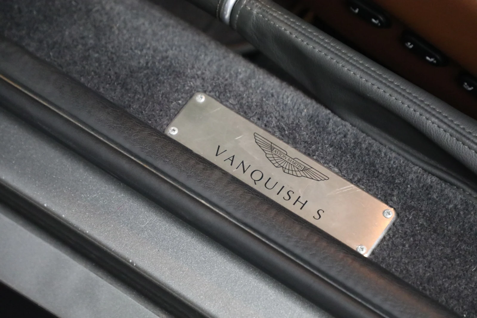 2006 Aston Martin V12 Vanquish S interior, door sill, Centenary Saddle Tan