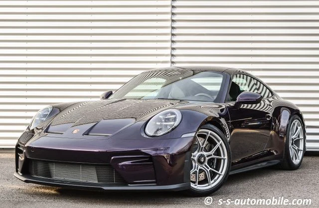 Porsche 911 (992) GT3 Touring, full-car front three-quarter view.