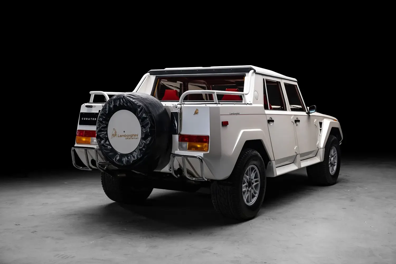 1990 Lamborghini LM002, rear three-quarter view, Bianco Perlato