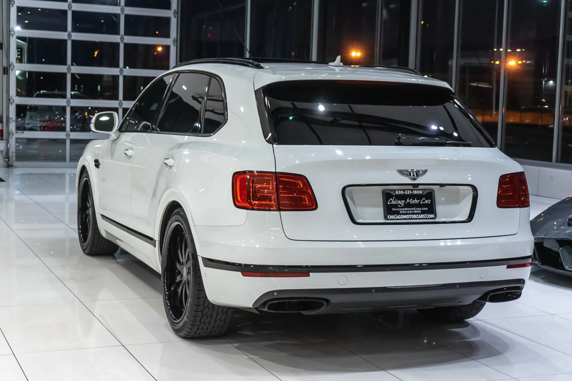 2017 Bentley Bentayga W12, rear three-quarter view, Glacier White Solid