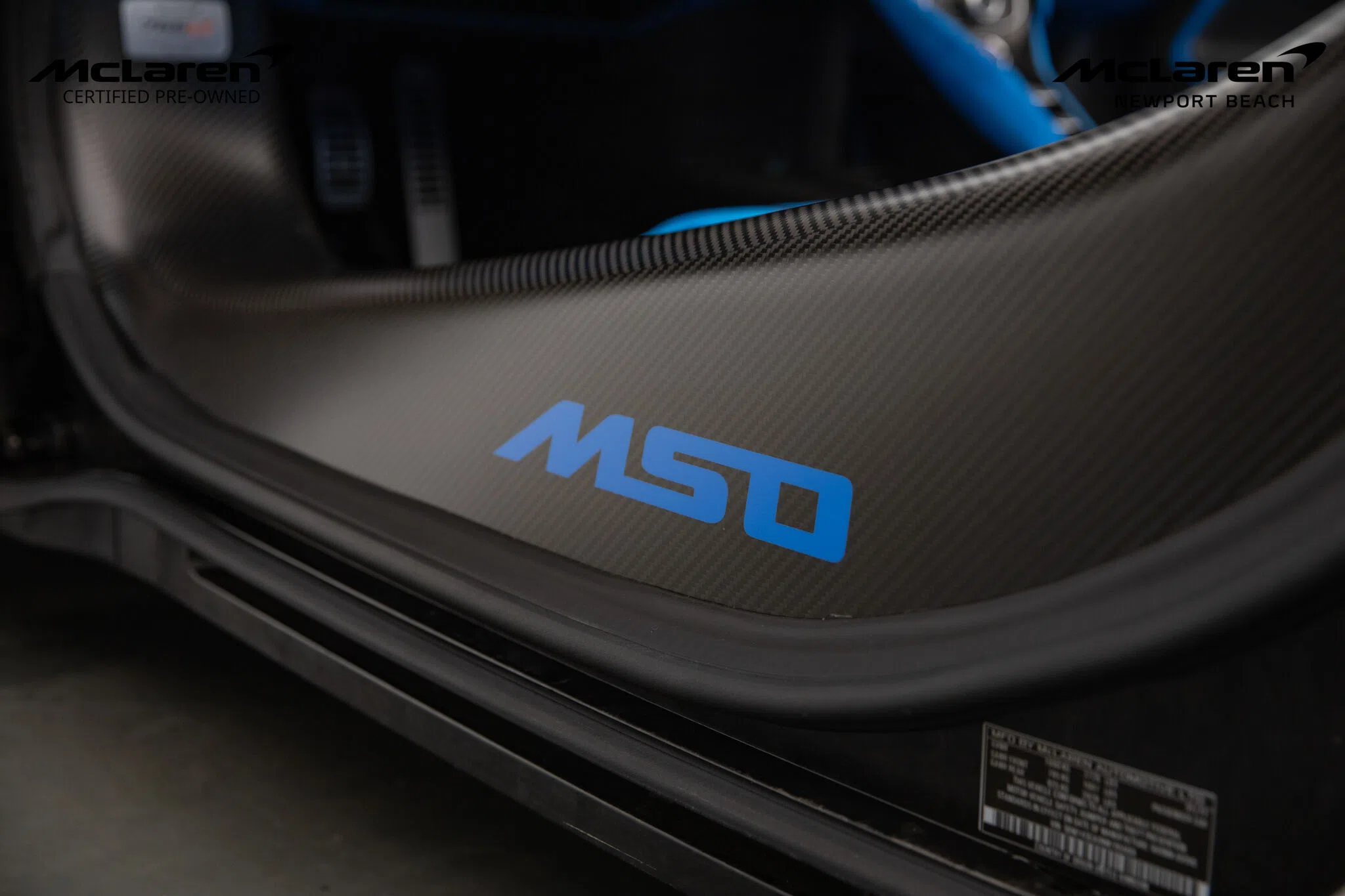 2022 McLaren 765LT interior, door sill, Carbon Black/Dove Gray